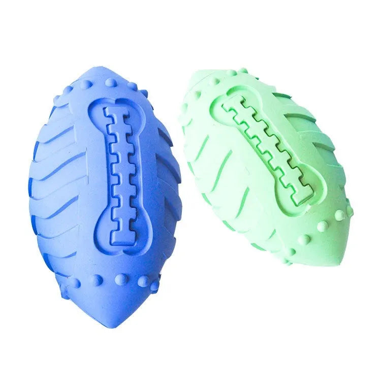 Light green rubber rugby ball dog toy with bite-resistant texture for interactive play and teeth cleaning.