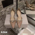 Women's pointed toe patent leather stiletto high heels with pearl decoration on the upper.