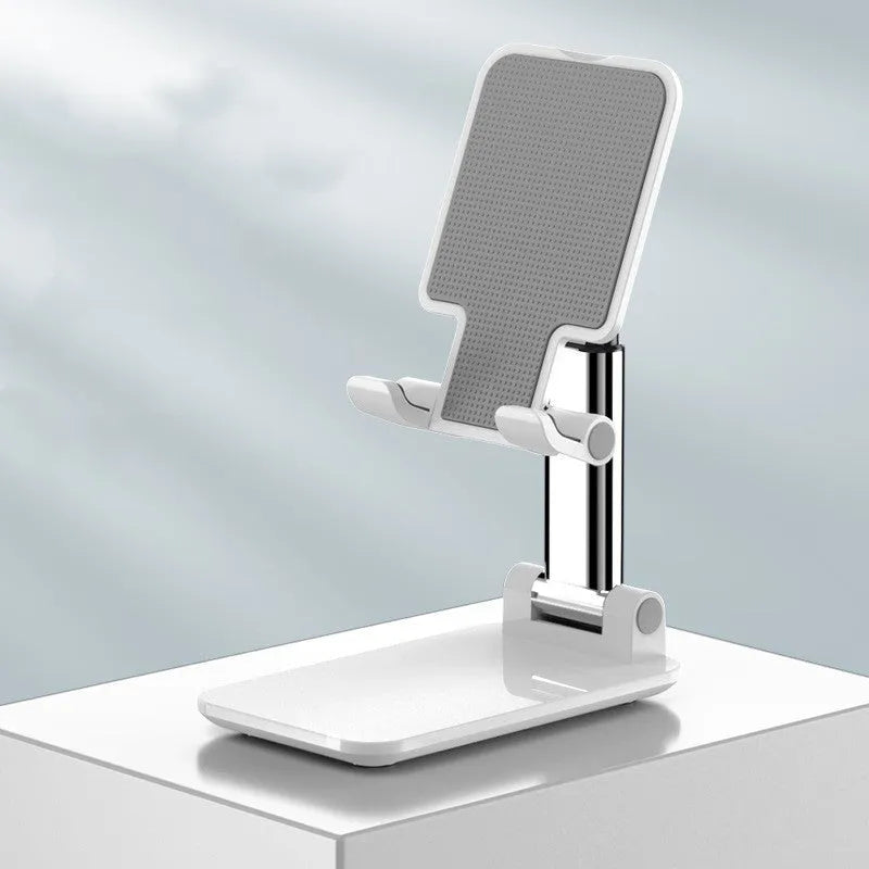 White telescopic folding mobile phone bracket on desktop holding smartphone