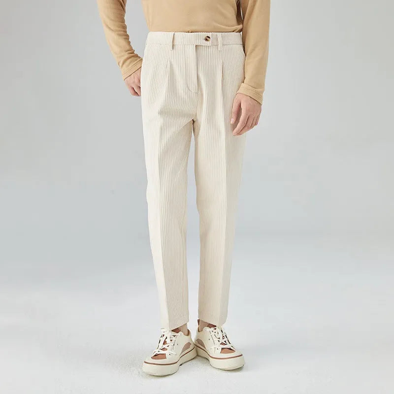 Men's beige straight-leg corduroy trousers with a mid waist and micro elasticity, laid flat.