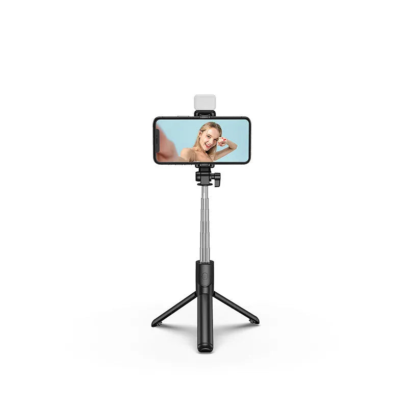 Black Bluetooth selfie stick with integrated tripod legs extended, showing 360-degree rotation mechanism and phone holder