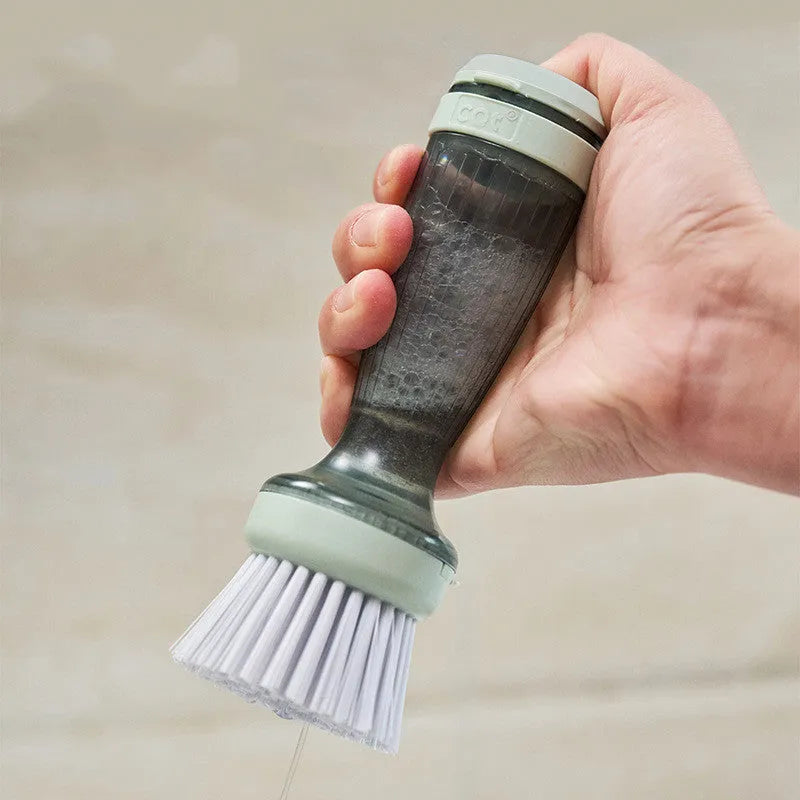 Milk white and mint green kitchen pot brush with soap dispenser in handle and replaceable brush head.