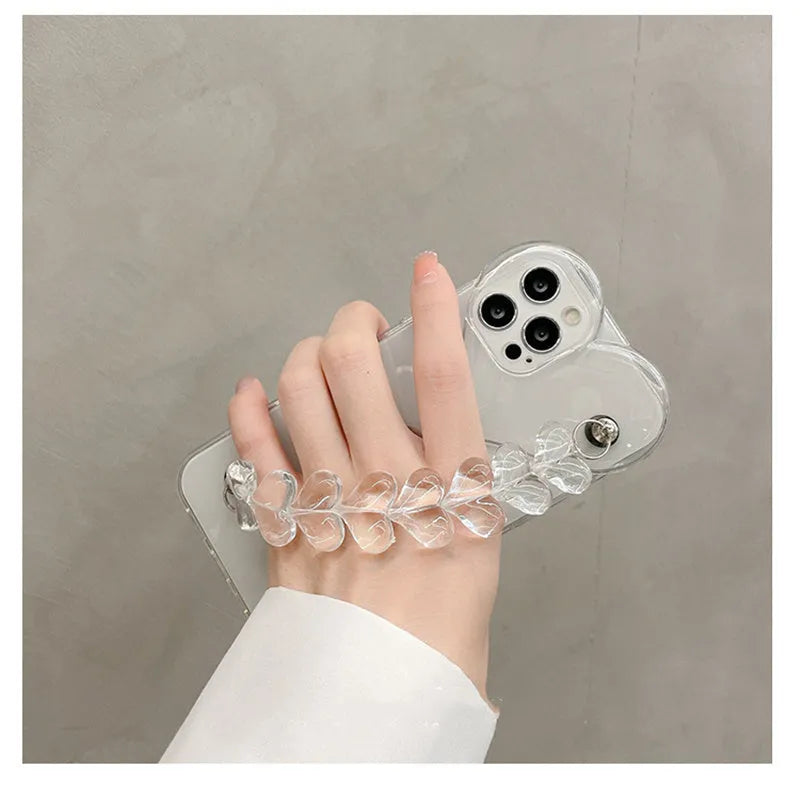 Transparent iPhone case with a soft TPU build and an integrated love heart chain, shown on a phone.