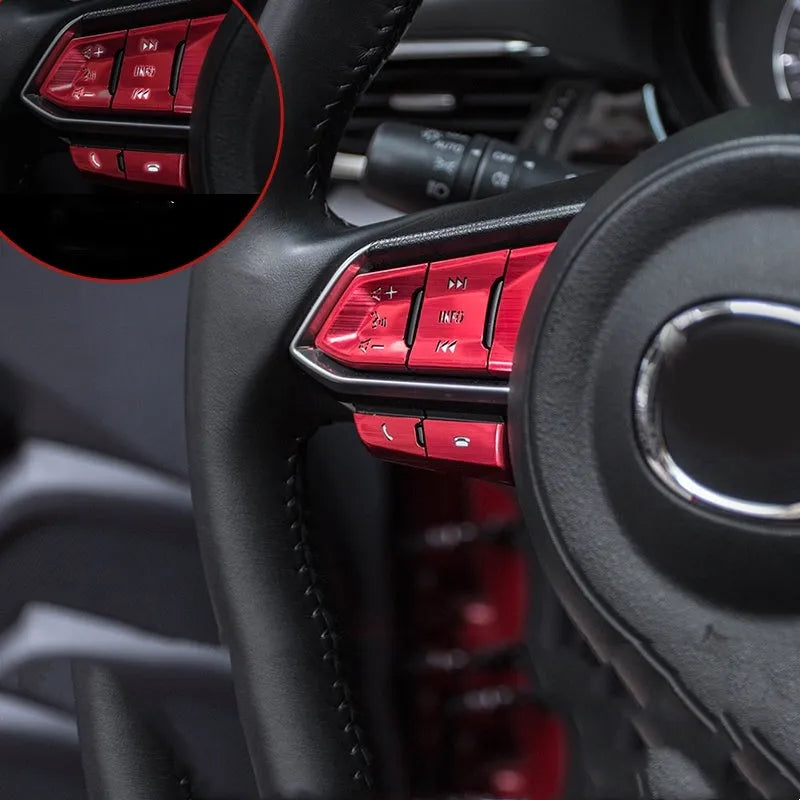 Set of eight aluminium alloy steering wheel button stickers in brushed red, silver, and blue finishes