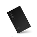 Black ultra-thin anti-loss alarm card for Apple devices on a table.