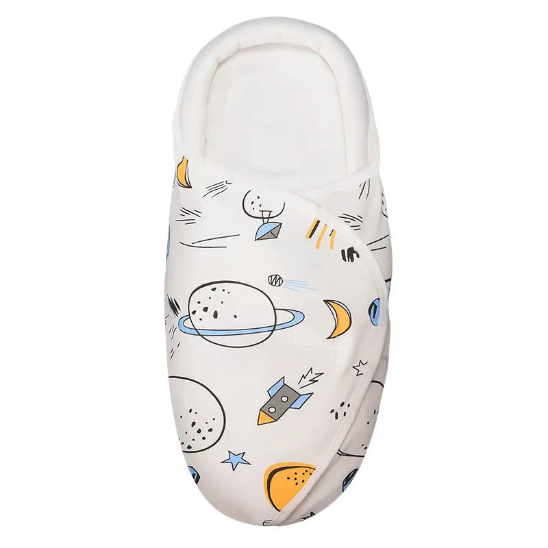 Cotton anti startle baby swaddle in a colourful pattern, laid flat showing its 30x60cm size.