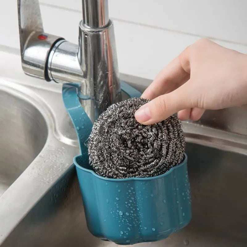 Nordic style dark blue plastic sink drain basket on a kitchen counter.