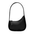 Leather ladies handbag in half-moon shape with wide shoulder strap and zipper opening