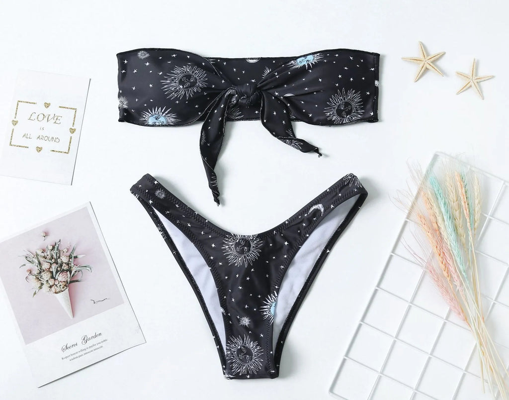 Black printed one-piece swimsuit with a split tube top and backless design.