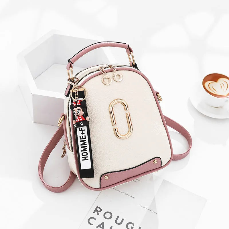 Women's PU leather oval fashion backpack with zip closure, multiple internal pockets and soft handle in white, red, black or pink