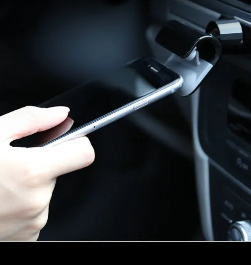 Black car phone holder showing 360-degree rotation mechanism and adhesive mounting base