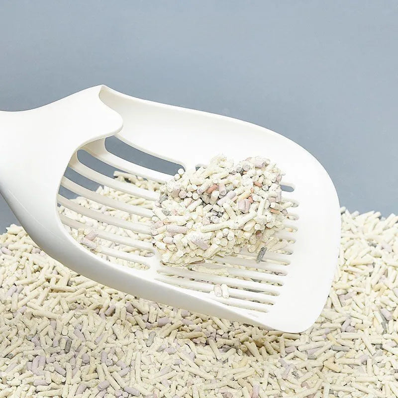 Large white plastic cat litter shovel with a slotted scoop head and handle.
