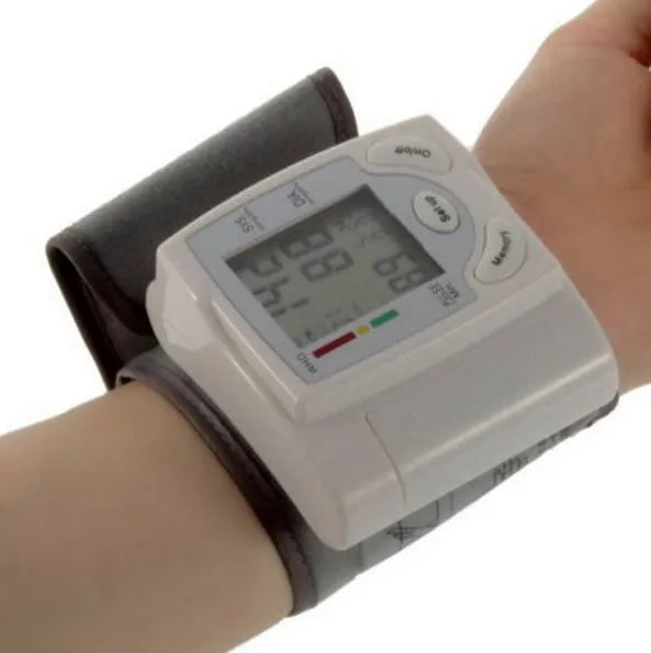 Grey portable wrist blood pressure monitor with digital display showing 70mm dimensions