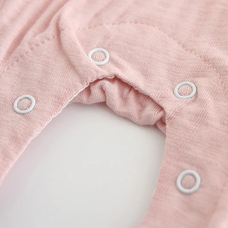 Pink embroidered cotton jumpsuit for baby girl with long sleeves and single-breasted closure