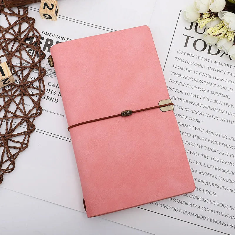 A6 notebook with imitation leather cover in choice of grey, pink, or red, showing cowhide rope style binding.