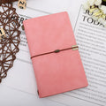 A6 notebook with imitation leather cover in choice of grey, pink, or red, showing cowhide rope style binding.