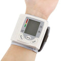Grey portable wrist blood pressure monitor with digital display showing 70mm dimensions