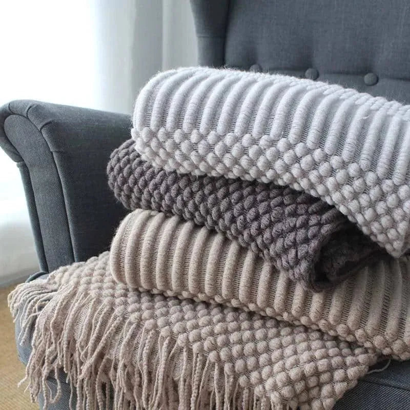 Small grey polyester nap blanket folded to show its texture and size.