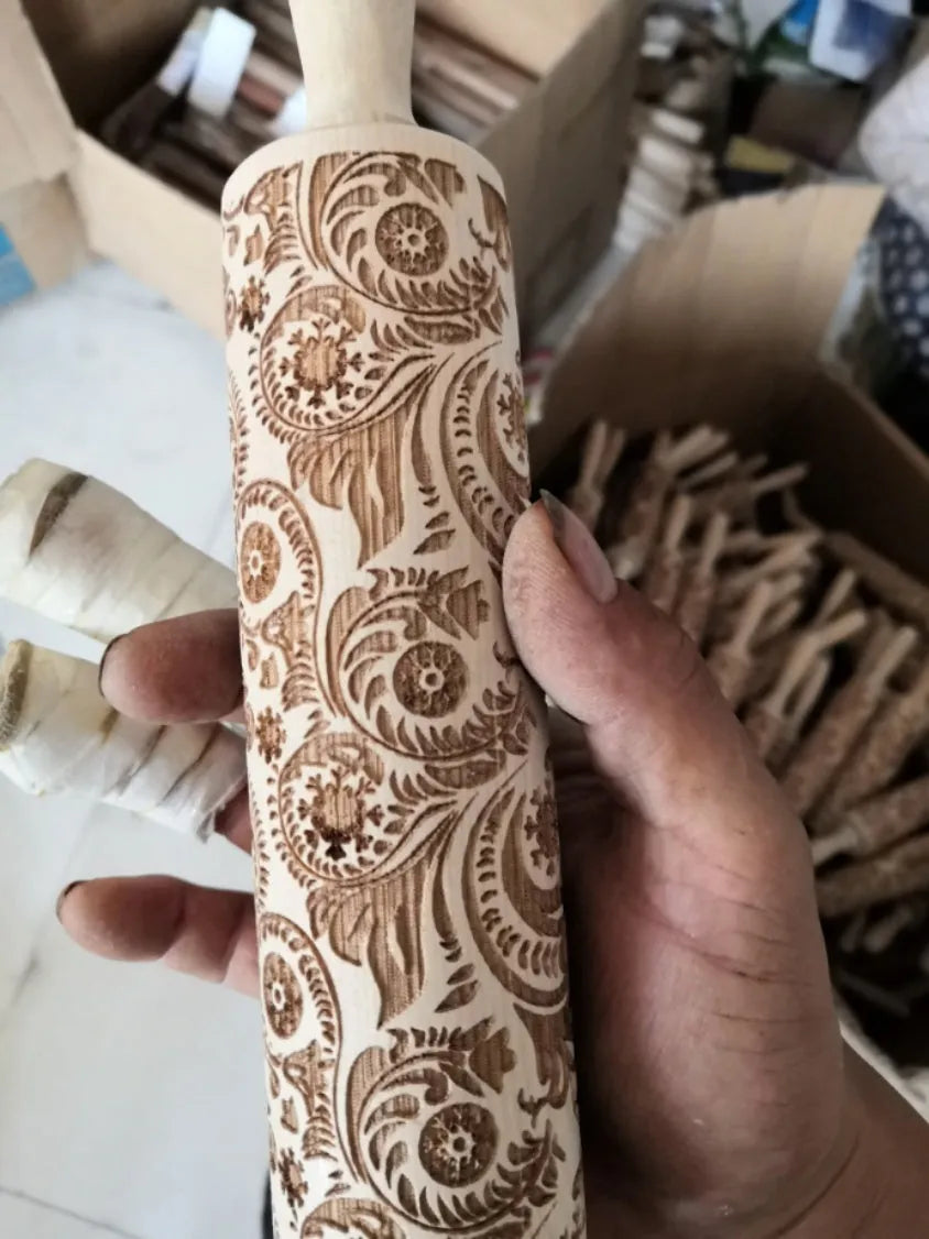 Solid wood rolling pin with embossed Christmas reindeer pattern on a 45cm long shaft.