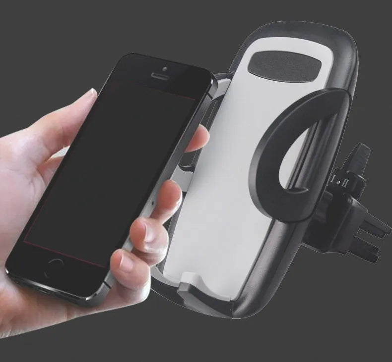 Black plastic mobile phone holder attached to car air conditioning vent with phone secured