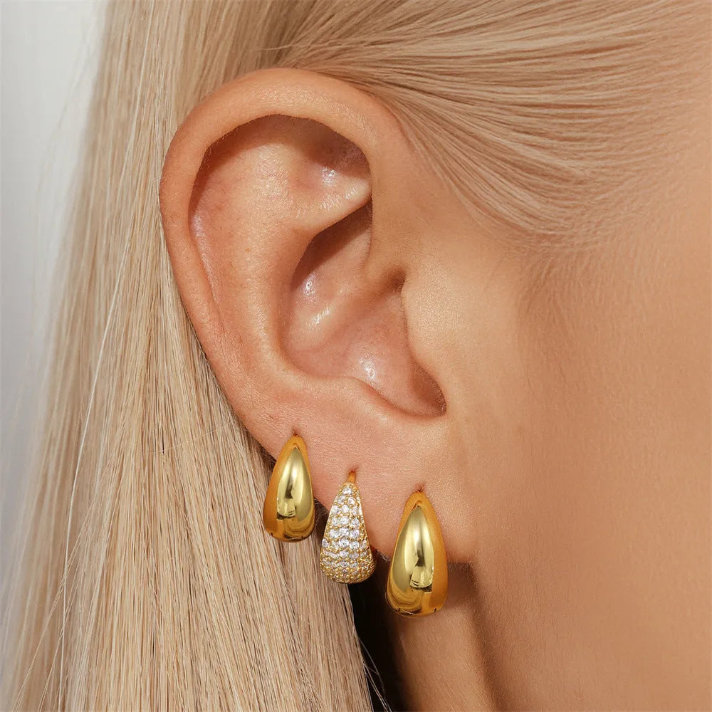 Geometric brass earclip earrings with electroplated golden finish and round elements
