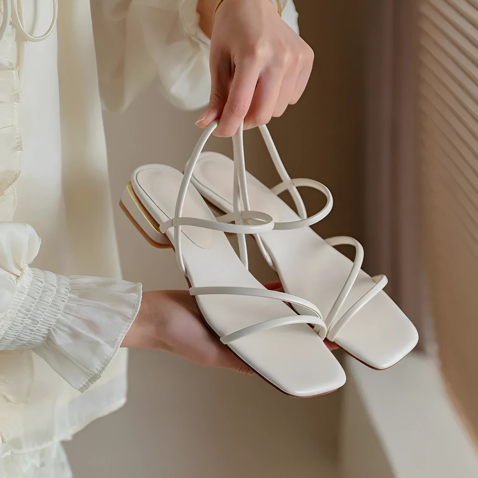 Women's flat strap gladiator sandals with square toe and adjustable ankle ties in beige.