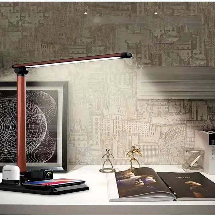 Black and white 4-in-1 LED desk lamp with integrated wireless phone charging pad visible on base