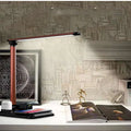 Black and white 4-in-1 LED desk lamp with integrated wireless phone charging pad visible on base
