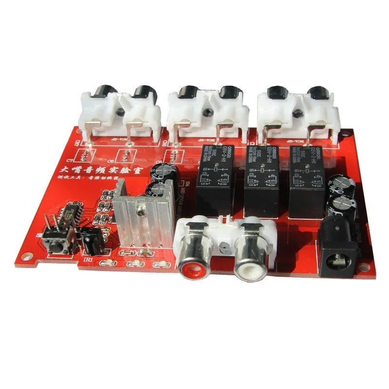 Silver aluminium alloy audio source switcher unit with front-panel switch button and infrared remote control.