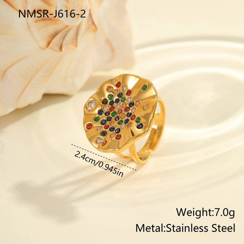 Geometric open mouth stainless steel ring with pleated setting and inlaid diamonds.