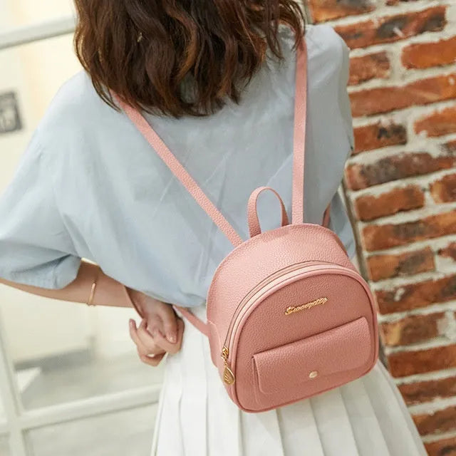 Women's small black backpack purse with adjustable straps showing 18.5cm length and zipper closure