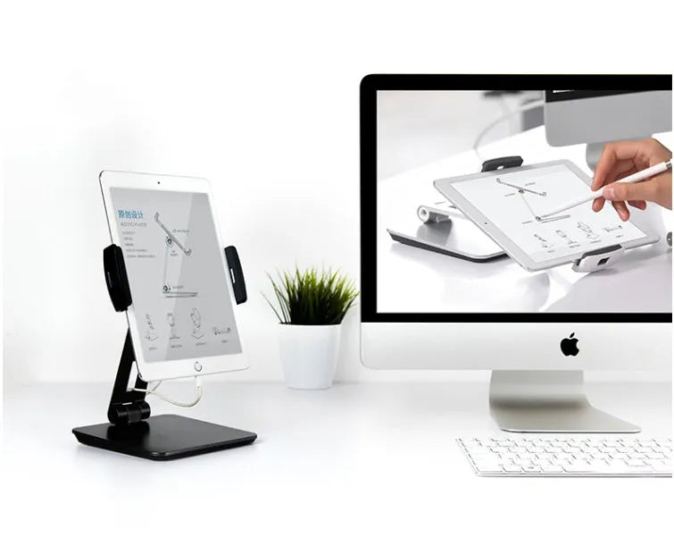 Silver foldable desktop holder supporting tablet with 360° rotation mechanism visible