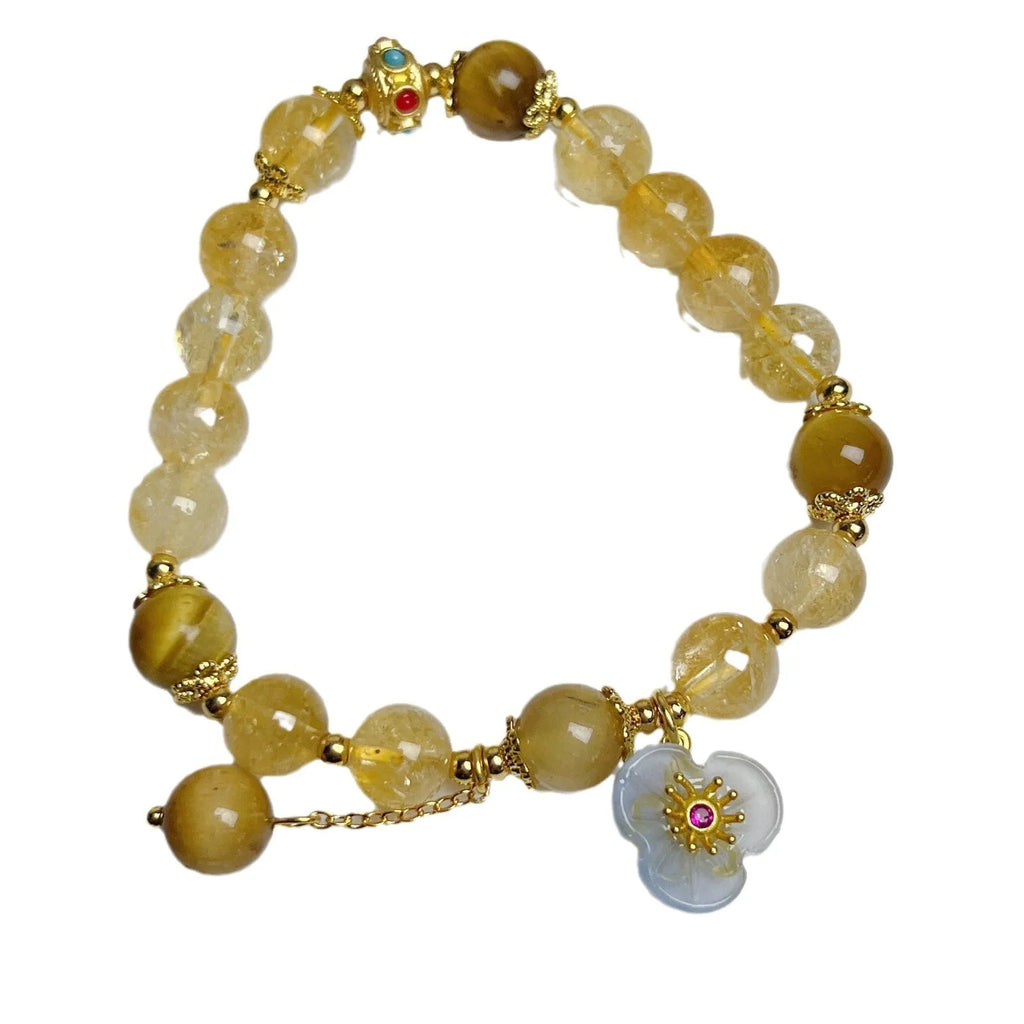 Handcrafted citrine crystal bracelet for women with a flower and tassel design.