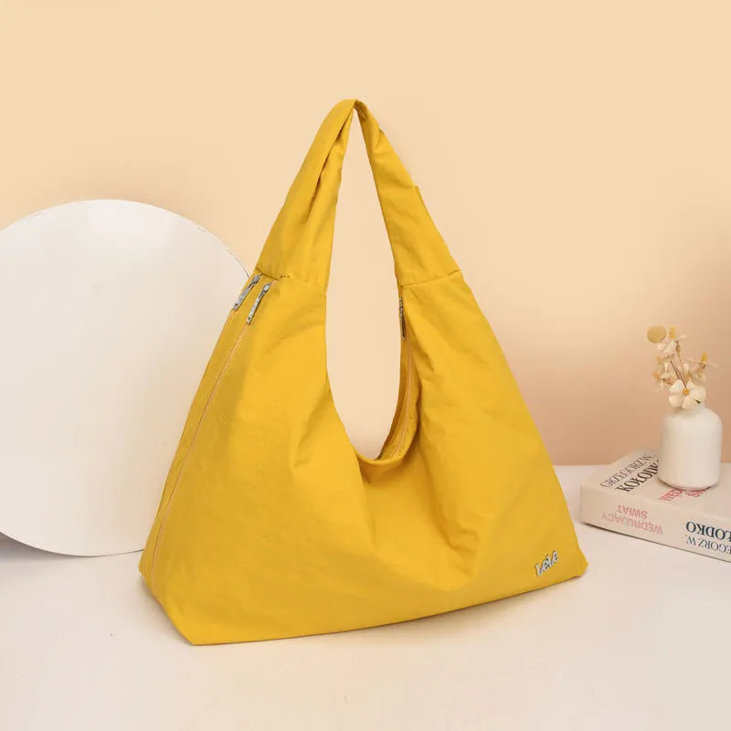Heart-shaped nylon underarm bag for women in black, blue, khaki, or yellow, showing large capacity and soft design
