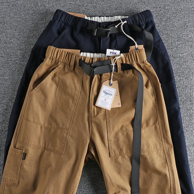 Men's khaki and dark blue cotton work trousers with a 3D cut and zip fly.