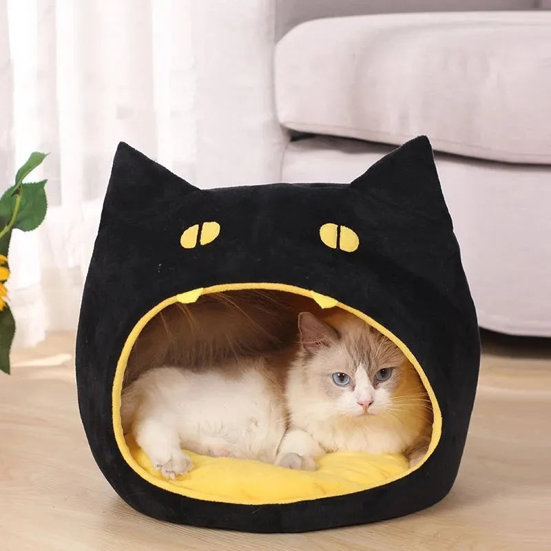 Grey covered cat cave pet bed with cat face design and anti-slip bottom.