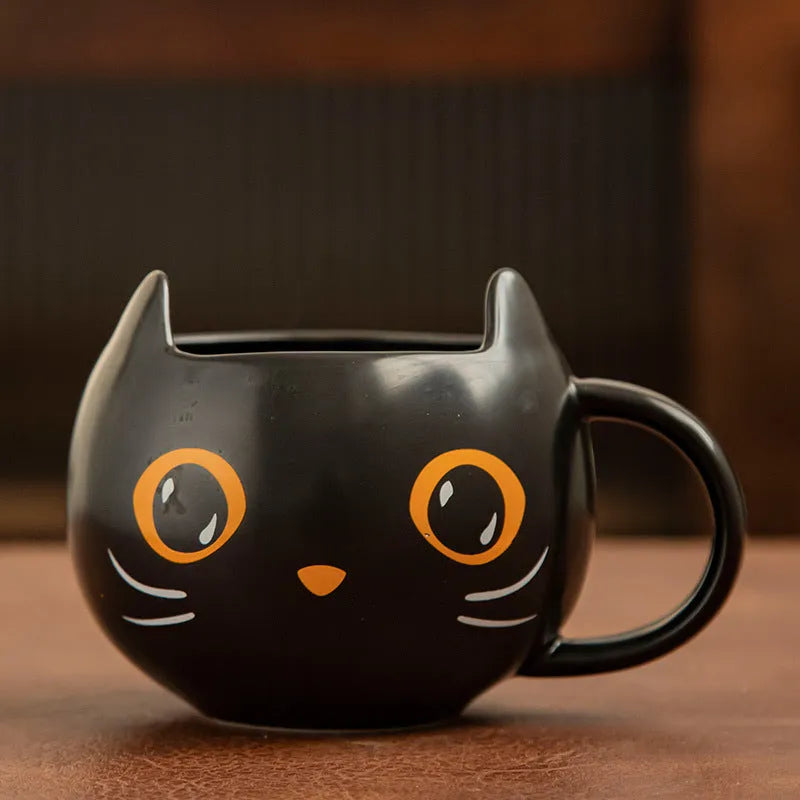Black ceramic novelty mug with Halloween pumpkin, spoon couple, and cat design, 355ml capacity.