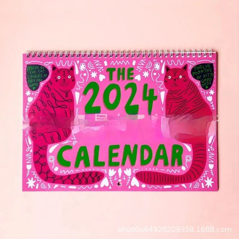 Cat-themed wall calendar showing 12-month grid with tear-off design and feline illustrations for each month