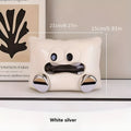 White ceramic tissue box holder with lid on a wooden coffee table.