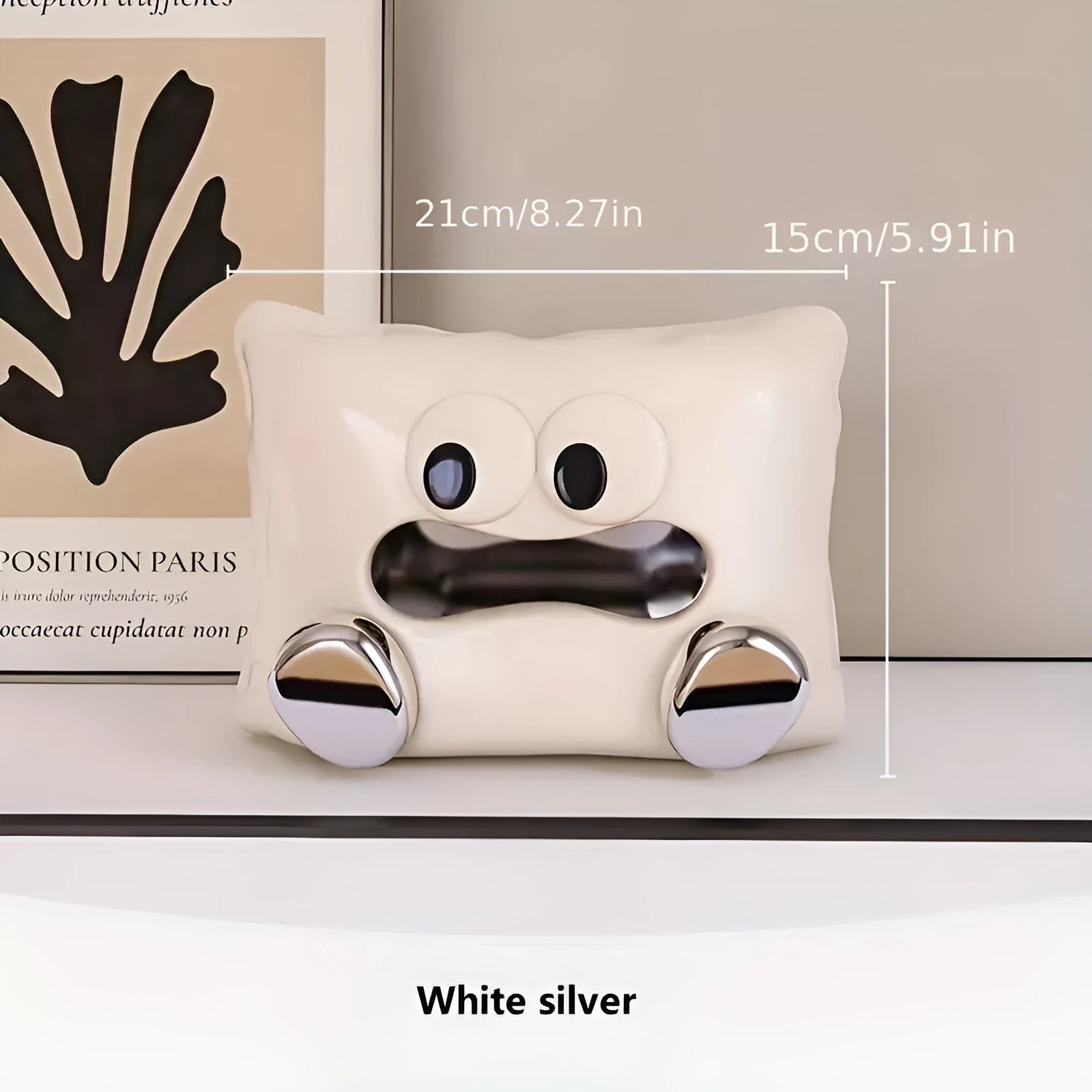 White ceramic tissue box holder with lid on a wooden coffee table.