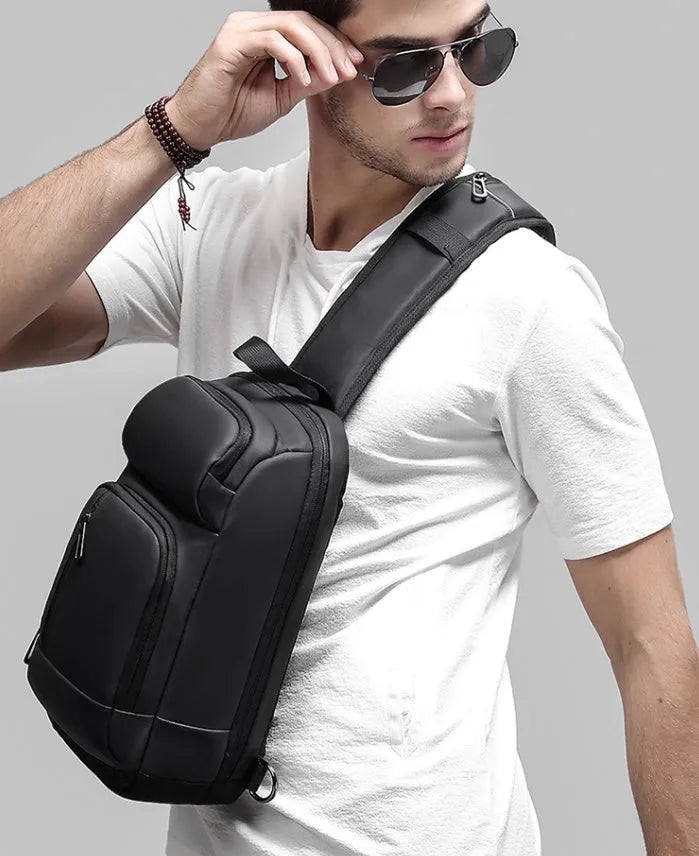 Black outdoor shoulder bag with air cushion strap and internal organisation compartments