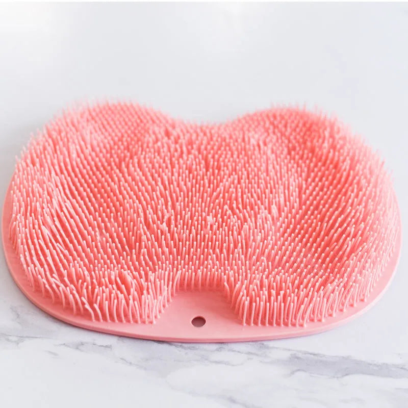 Orange massage bath brush with suction cups and silicone bristles on a 23x30cm TPR mat