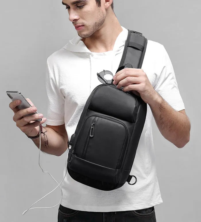Black outdoor shoulder bag with air cushion strap and internal organisation compartments