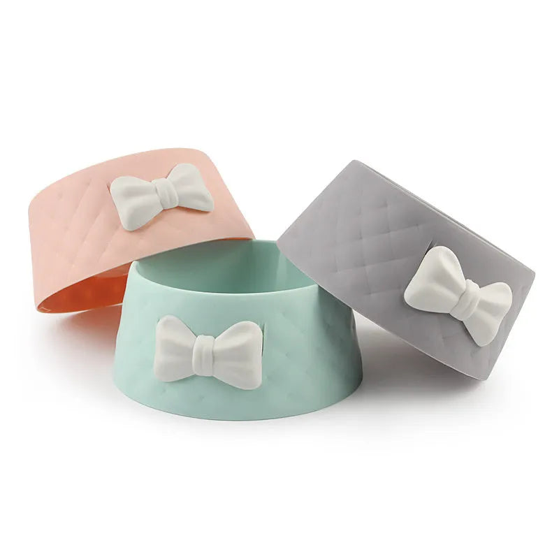 Bow-shaped cat bowl dog bowl in PP plastic, shown in pink, green, and grey.