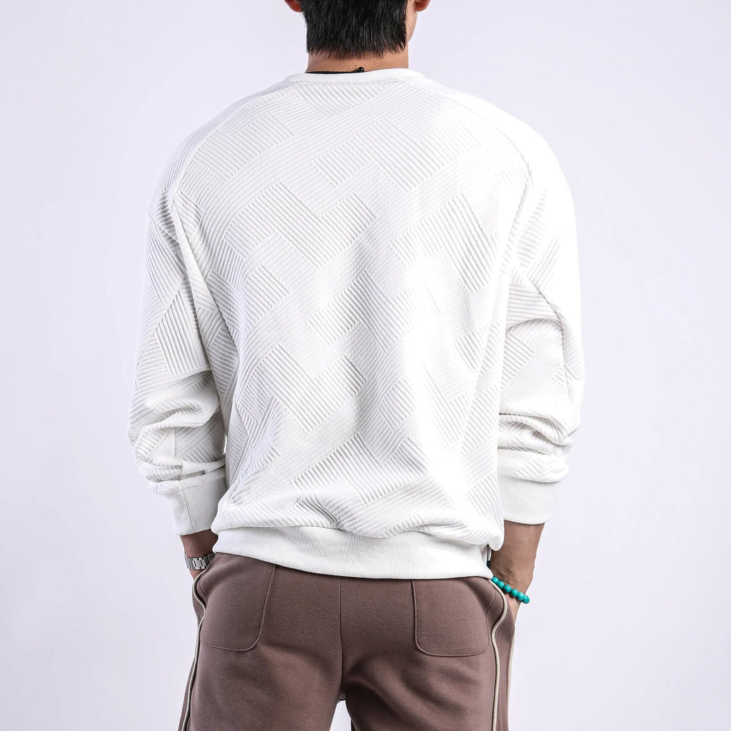 Men's solid colour long-sleeved sweater in twill jacquard fabric, shown in a loose fit with a round neck.