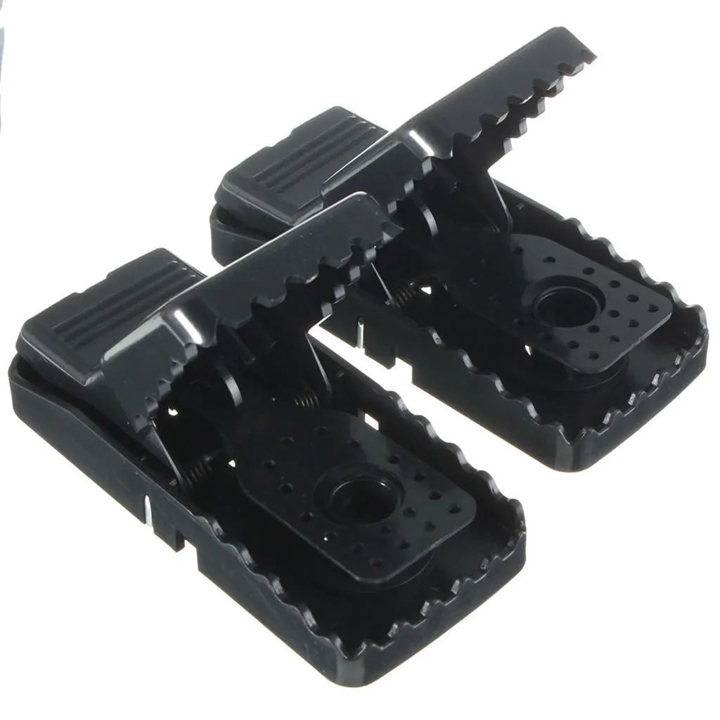Six black plastic snap mousetraps showing smooth surface and compact size