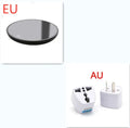Black coffee cup warmer pad with temperature switch on a desk next to a mug.