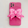 Rose Red iPhone case with pink bow design and a folded-out kickstand on the back.