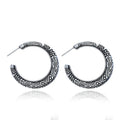 Pair of bronze C-shaped alloy earrings with detailed vintage engraving on the surface.