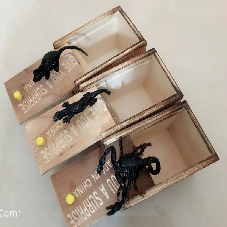 Wooden prank scare box closed, dimensions 9.1cm x 6.1cm x 6.5cm, for April Fools' jokes.
